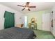 This bedroom has a ceiling fan and desk at 10611 Quail Roost Rd, Bahama, NC 27503