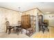 A dining room includes a vintage china cabinet, wood chairs, and an adjacent antique parlor stove at 10611 Quail Roost Rd, Bahama, NC 27503