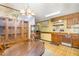 A kitchen with vintage cabinets, appliances, a wooden table, and wallpaper with a distinctive charm at 10611 Quail Roost Rd, Bahama, NC 27503