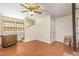 Living room with wood floors, ceiling fan, and a window at 10611 Quail Roost Rd, Bahama, NC 27503