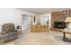 The living room includes a brick fireplace, a sliding glass door, and patterned sofa and chair at 10611 Quail Roost Rd, Bahama, NC 27503