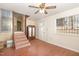 Living room featuring wood floors, ceiling fan and windows at 10611 Quail Roost Rd, Bahama, NC 27503