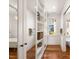 Bright bathroom featuring built-in shelving, a freestanding tub, and hardwood floors at 114 W Lynch St, Durham, NC 27701