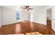 Large bedroom with hardwood floors and two windows letting in natural light at 114 W Lynch St, Durham, NC 27701