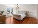 Serene main bedroom with hardwood floors, a stylish light fixture, and ample natural light at 114 W Lynch St, Durham, NC 27701