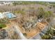 Aerial view of a neighborhood with mature trees, streets, and a community pool at 1195 Champion Dr, Cary, NC 27511