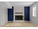 Finished basement with brick fireplace with mantle, neutral walls, and tile flooring at 1195 Champion Dr, Cary, NC 27511