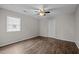 Bedroom featuring modern ceiling fan, window with blinds, and wood-look flooring at 1195 Champion Dr, Cary, NC 27511
