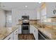 Kitchen featuring stainless steel appliances, white cabinets and granite countertops at 1195 Champion Dr, Cary, NC 27511