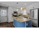 Bright kitchen featuring island, stainless steel appliances, and white cabinets at 1195 Champion Dr, Cary, NC 27511