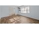 Cozy living room with hardwood floors, a large window, and seamless access to other rooms at 1195 Champion Dr, Cary, NC 27511