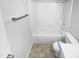 Bathroom featuring a shower-tub combination, modern fixtures, and tiled flooring at 1216 Armstrong Cir, Raleigh, NC 27610