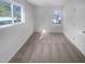 Bright bedroom with two windows, carpeted floor, and fresh neutral paint at 1216 Armstrong Cir, Raleigh, NC 27610