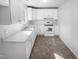 Bright kitchen features white cabinetry, countertops, and appliances at 1216 Armstrong Cir, Raleigh, NC 27610