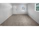 Bright, carpeted living room featuring natural light from the window at 1216 Armstrong Cir, Raleigh, NC 27610