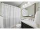 Bathroom with shower and tub with a large mirror and dark wood vanity at 1305 Bridgeport Dr, Raleigh, NC 27615