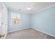 Bedroom with light blue walls, carpet floors, window, and a ceiling fan at 1305 Bridgeport Dr, Raleigh, NC 27615