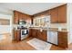 Efficient kitchen featuring stainless steel appliances, granite countertops, and wood cabinets at 1305 Bridgeport Dr, Raleigh, NC 27615