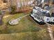 A gorgeous backyard with a view of the lake, a covered porch, and a built-in fire pit at 1326 Lochshire Dr, Burlington, NC 27215
