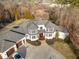 Elegant home with manicured grounds, a three-car garage, and a circular driveway at 1326 Lochshire Dr, Burlington, NC 27215