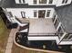 Aerial view of the back patio with doors to the sunroom and white brick exterior at 1326 Lochshire Dr, Burlington, NC 27215
