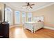 Bright bedroom featuring hardwood floors, large windows, and neutral color palette at 1326 Lochshire Dr, Burlington, NC 27215