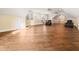Large bonus room with hardwood floors, featuring natural light, and two black recliners at 1326 Lochshire Dr, Burlington, NC 27215
