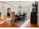 Elegant dining room with chandelier, stylish furnishings, and hardwood floors at 1326 Lochshire Dr, Burlington, NC 27215