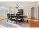 Formal dining room with contemporary lighting, a dark wood table and view of the surrounding lawn at 1326 Lochshire Dr, Burlington, NC 27215