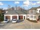 An aerial view of a three-car garage, circular driveway, and tasteful exterior at 1326 Lochshire Dr, Burlington, NC 27215