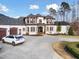 Elegant home with three-car garage, circular driveway, and professionally landscaped yard at 1326 Lochshire Dr, Burlington, NC 27215