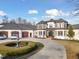 Elegant home with a circular driveway, a central fountain, and manicured landscaping at 1326 Lochshire Dr, Burlington, NC 27215