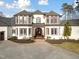 Imposing two-story residence featuring a circular driveway, well-kept lawn, and stately facade at 1326 Lochshire Dr, Burlington, NC 27215