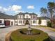 Stately residence with a charming fountain, a circular drive, and a traditional facade at 1326 Lochshire Dr, Burlington, NC 27215