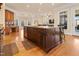 Spacious kitchen featuring an island with granite counters, custom cabinets, and wood flooring at 1326 Lochshire Dr, Burlington, NC 27215