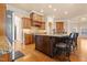Spacious kitchen with an oversized island, granite countertops, seating, and wooden cabinetry at 1326 Lochshire Dr, Burlington, NC 27215
