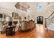 Inviting living room with fireplace, hardwood floors, wrought iron staircase and soaring ceilings at 1326 Lochshire Dr, Burlington, NC 27215
