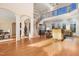 Open-concept living space featuring hardwood floors, soaring ceilings, and a wrought iron staircase at 1326 Lochshire Dr, Burlington, NC 27215