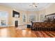 Comfortable main bedroom with hardwood floors, ceiling fan, and a door to the outside balcony at 1326 Lochshire Dr, Burlington, NC 27215