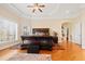 Well-lit main bedroom showcasing hardwood floors, tray ceiling, and a large window at 1326 Lochshire Dr, Burlington, NC 27215