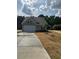 Charming one-story home with gray siding, a two-car garage, and a well-maintained front lawn at 135 Baneberry Dr, Broadway, NC 27505