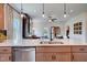 Kitchen island with quartz countertop, stainless dishwasher and pendant lighting at 135 Baneberry Dr, Broadway, NC 27505