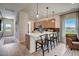 The kitchen island has bar stool seating, pendant lighting, and a view into the living area at 135 Baneberry Dr, Broadway, NC 27505