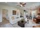Inviting living room features a ceiling fan, modern decor, and an open layout to the kitchen at 135 Baneberry Dr, Broadway, NC 27505