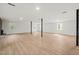 Large finished basement space with laminate wood flooring, many windows, and support beams at 1411 Rosewood St, Durham, NC 27701