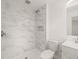 Bathroom featuring a glass-enclosed shower with marble-look tiles and a modern vanity at 1411 Rosewood St, Durham, NC 27701