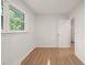 Bright bedroom featuring a window and light hardwood floors at 1411 Rosewood St, Durham, NC 27701