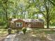 Charming brick ranch-style home with mature trees and a well-maintained front lawn at 1411 Rosewood St, Durham, NC 27701