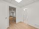 Hallway with vinyl flooring leading to a bathroom and additional room, freshly painted walls at 1411 Rosewood St, Durham, NC 27701