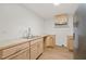 Kitchen with wood cabinets, stainless steel refrigerator, and ample counter space at 1411 Rosewood St, Durham, NC 27701
